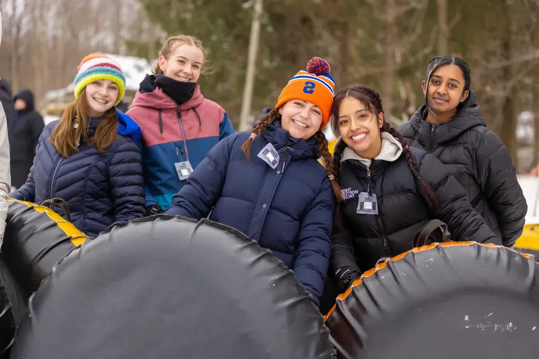 Five Students enjoy snow tubing.